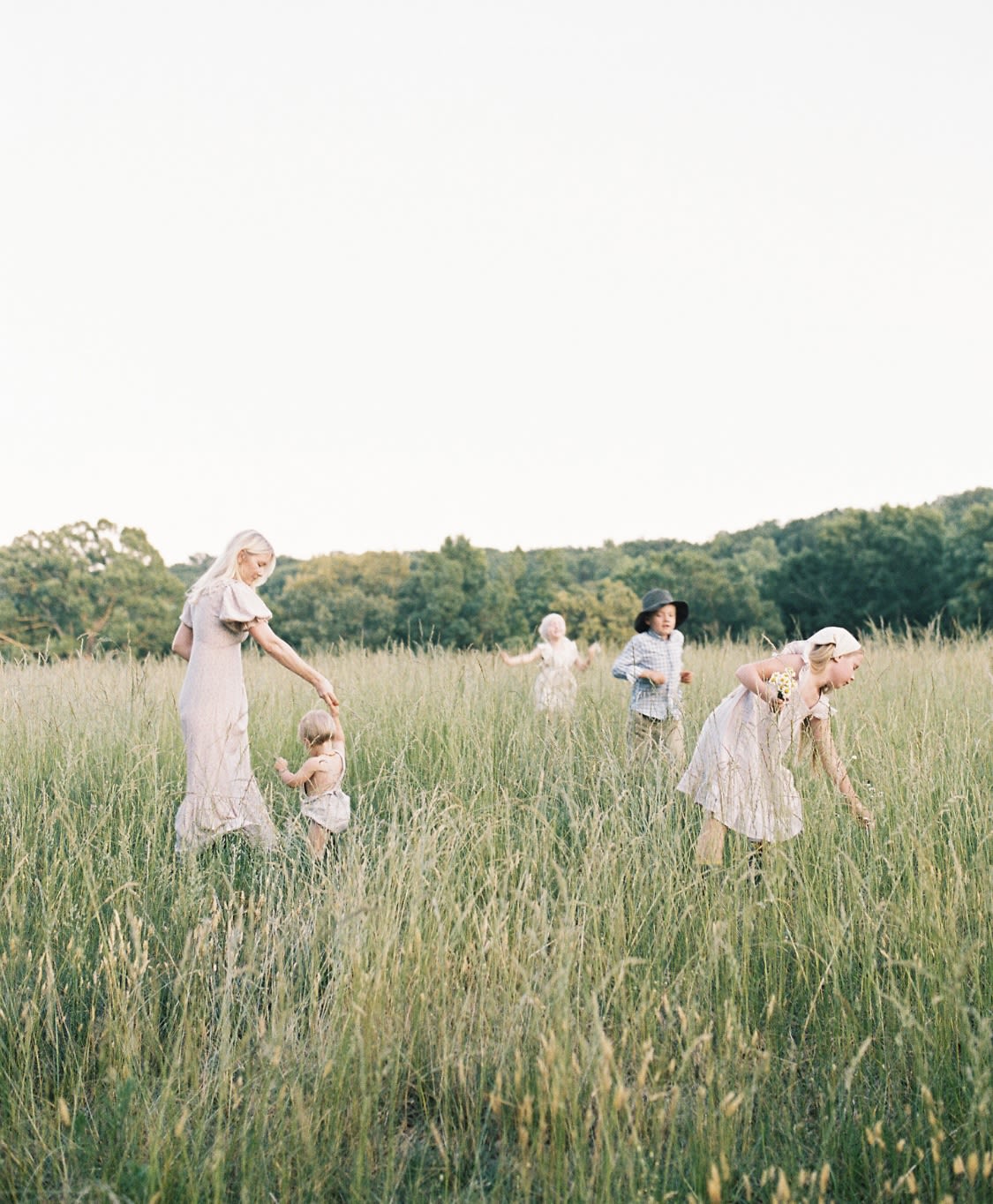 Photo of Motherhood Photographer Alexandria Smith with children in field